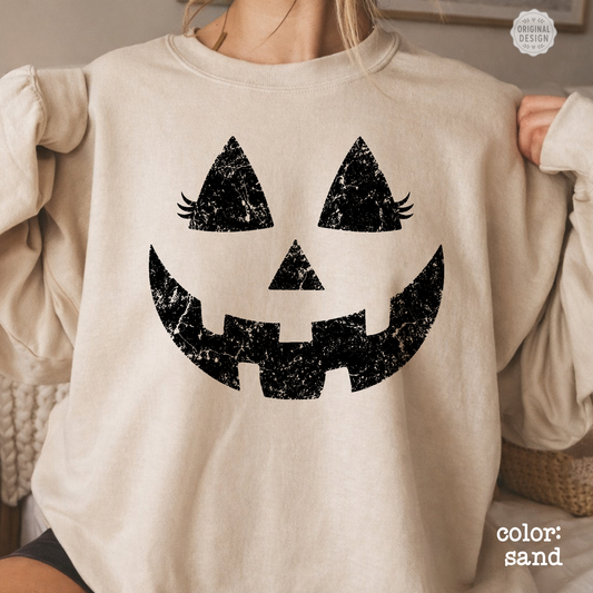 Close-up shot of the high-quality retro jack-o'-lantern face print on the front of the sweatshirt.
